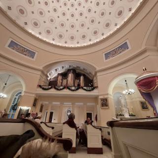 An elegant interior featuring a stunning dome and ornate architectural details.
