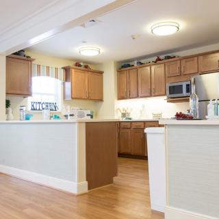 Modern kitchen with wooden cabinets and appliances.