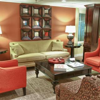 A cozy living room with a mix of furniture and warm lighting.