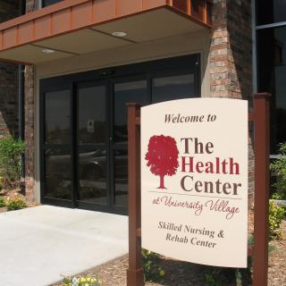 Entrance to The Health Center with a welcoming sign.
