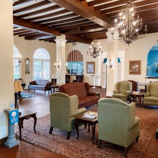 Elegant lobby with classic furniture and chandeliers.