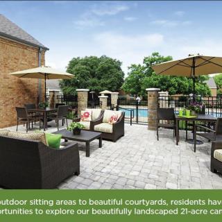 A landscaped courtyard with comfortable outdoor seating and a pool, perfect for relaxation.
