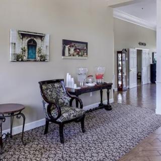 A cozy living space with elegant furniture and a beverage station.