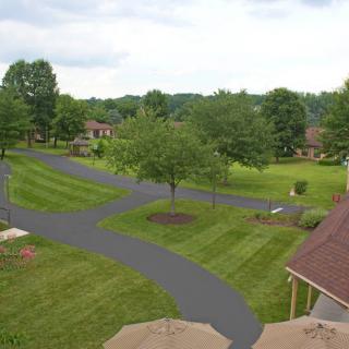 A serene suburban landscape with well-maintained lawns and winding pathways.