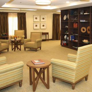 A cozy living room setup with comfortable chairs and a decorative bookshelf.