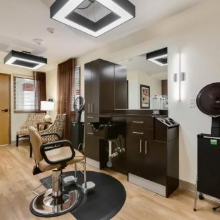 A modern hair salon interior with sleek furniture and stylish lighting.