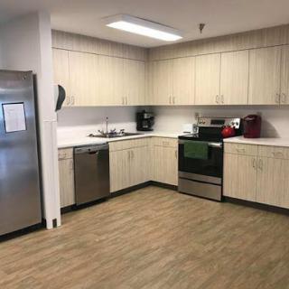 A modern kitchen featuring light-colored cabinets and essential appliances.