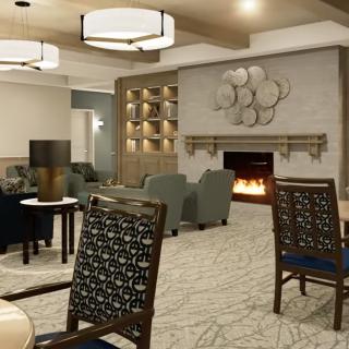 A modern lounge area featuring a fireplace, comfortable seating, and stylish decor.