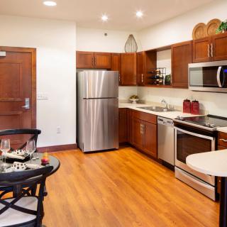 Modern kitchen with stainless steel appliances and wooden cabinetry.