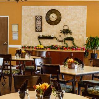 A cozy dining area with neatly arranged tables and decorative wall elements.