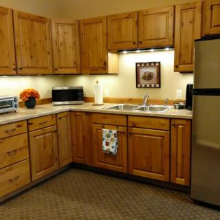 A cozy kitchen with wooden cabinetry and modern appliances.
