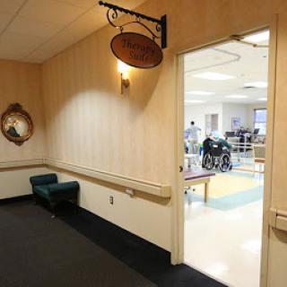 A view of a hallway with a sign, leading to an area equipped for mobility assistance.