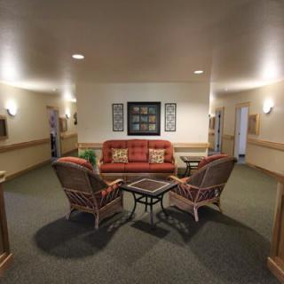 A cozy lobby seating area with a sofa, chairs, and a small table.