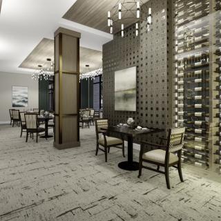 A modern restaurant interior featuring elegant dining spaces with wine racks and sophisticated lighting.