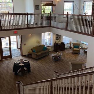 A spacious two-story lobby with comfortable seating and large windows.