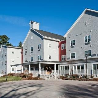 A modern residential building with multiple stories and a well-maintained exterior.