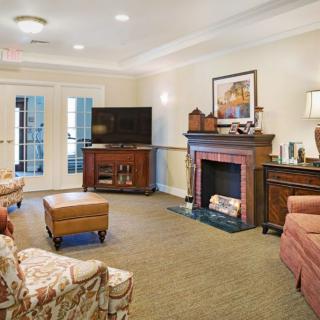 A cozy living room with a fireplace, television, and comfortable seating.