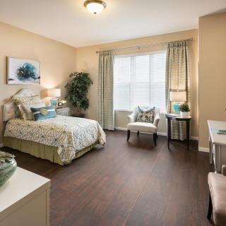 A cozy bedroom with elegant decor and ample natural light.