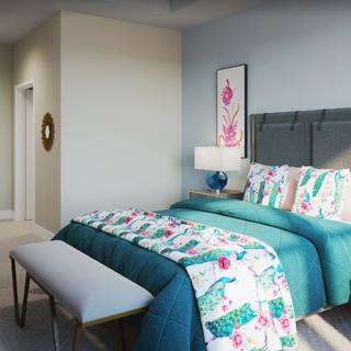 A stylishly decorated bedroom featuring colorful bedding and modern furniture.