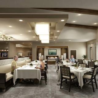 A spacious and elegantly decorated restaurant dining area with tables set for guests.