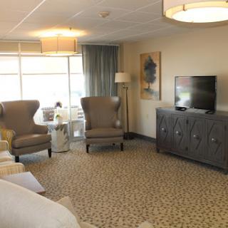 A cozy living room with elegant furnishings and ample natural light.
