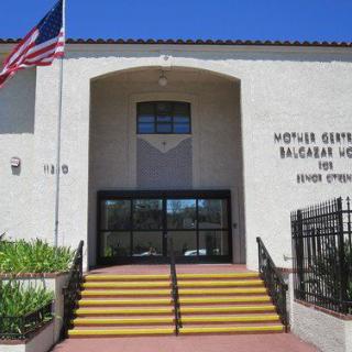 Entrance of a school building with steps and an American flag.