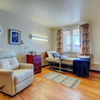 A well-furnished hospital room designed for patient comfort and care.