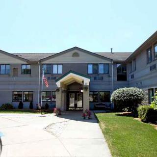 Front view of a residential building with landscaped surroundings.
