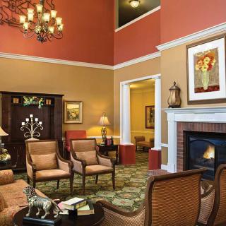 A cozy living room with elegant furniture, a fireplace, and warm lighting.