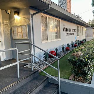 Entrance to a clinic with a ramp and well-maintained landscaping.