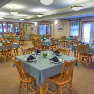 A neatly arranged dining room with tables set for service.