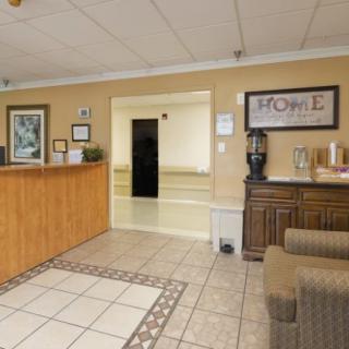 A welcoming reception area with a front desk and seating in a well-lit lobby.