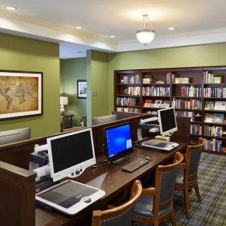 A quiet library space with computers and bookshelves for study and research.