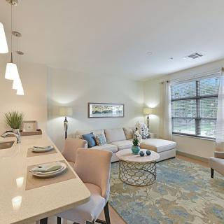 A modern, open-concept living room with stylish decor and abundant natural light.
