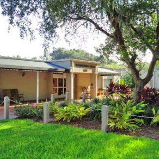 A cozy house surrounded by lush greenery and a well-maintained garden.