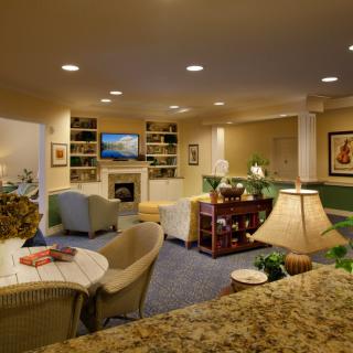 A cozy living room with a fireplace, television, and comfortable seating area.
