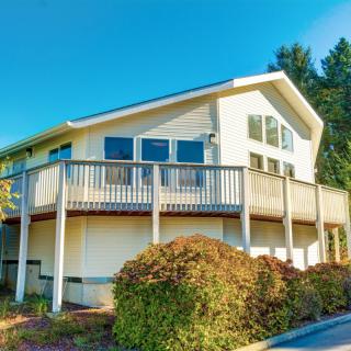 A modern residential house with a spacious deck on a sunny day.