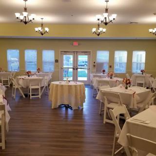 An elegantly set banquet hall with neatly arranged tables and chairs, ready for an event.