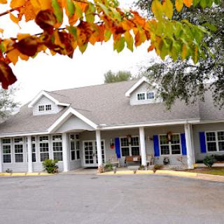 A cozy residential building surrounded by vibrant autumn foliage.
