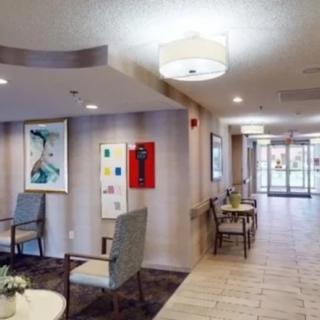 A well-lit lobby area with seating and artwork on the walls.