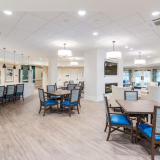 A modern and spacious dining area with elegant tables and chairs, featuring stylish lighting fixtures.
