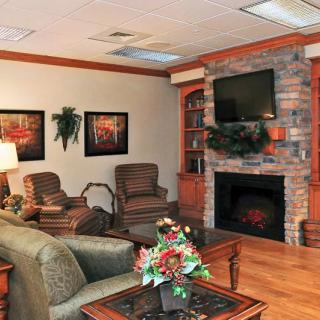 A cozy living room with a fireplace, television, and comfortable seating.