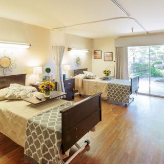 A bright and inviting hospital room designed for patient comfort, featuring two beds and natural light.
