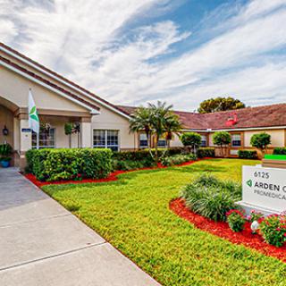 A healthcare facility with well-maintained landscaping and clear signage on a sunny day.