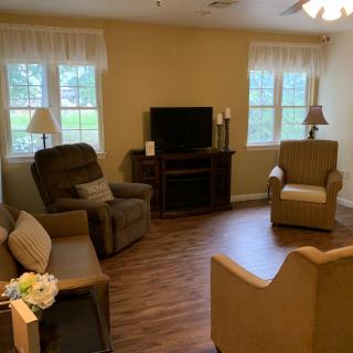 A cozy living room with seating and a television.