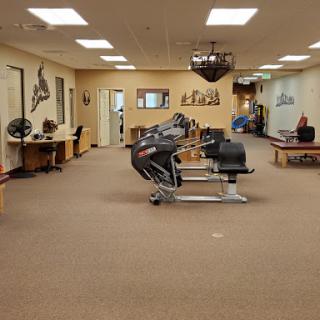 A spacious fitness studio equipped with various exercise machines and a welcoming atmosphere.