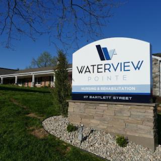 Waterview signage in a landscaped area, showcasing the building's name.