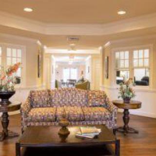A cozy living room with elegant furnishings and warm lighting.