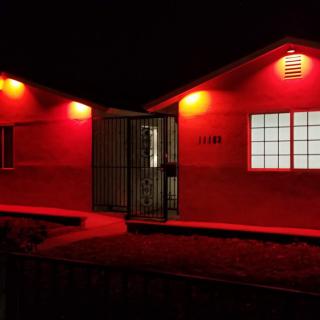 A building illuminated by red lights at night.