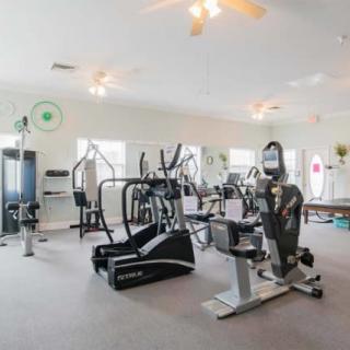 A clean and well-equipped gym with various exercise machines.